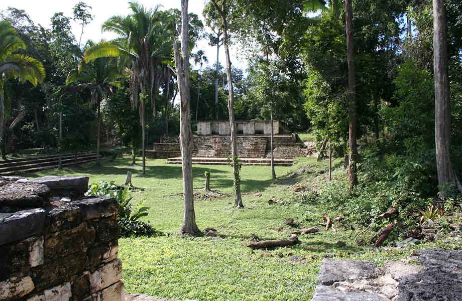 The rugged beauty of Aguateca, with ancient Mayan ruins perched on limestone cliffs amidst dense rainforest in Guatemala’s Petén region.