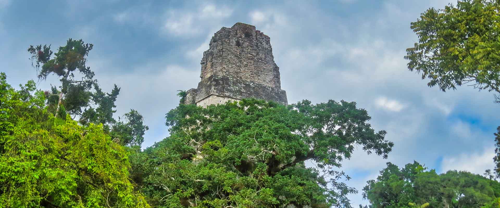 Astonishing view of the ancient Tikal Mayan pyramids amidst lush jungle, gateway to more hidden ruins in Guatemala.