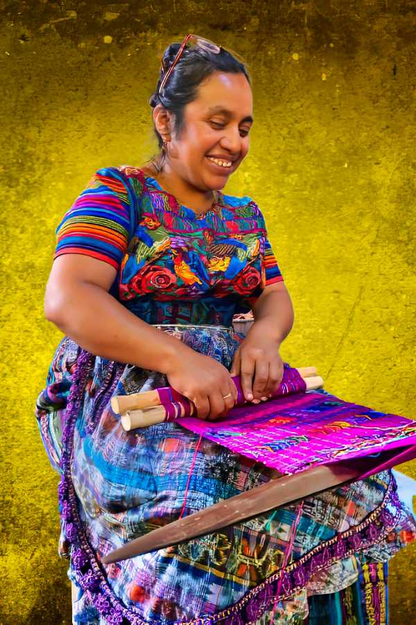 "Maya woman weaving on a backstrap loom in Antigua, Guatemala - A skilled artisan showcasing the ancient art of traditional weaving and cultural heritage."